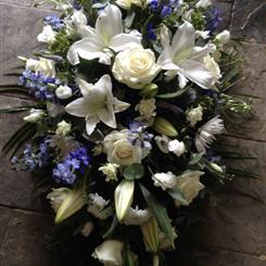 Blue and white casket spray