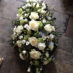 Whites, creams and greens casket spray